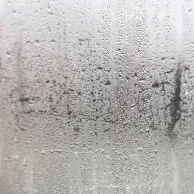 Condensation on window glass caused by high humidity in winter.